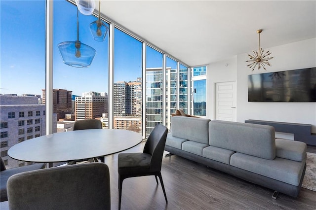 dining space featuring expansive windows and wood finished floors