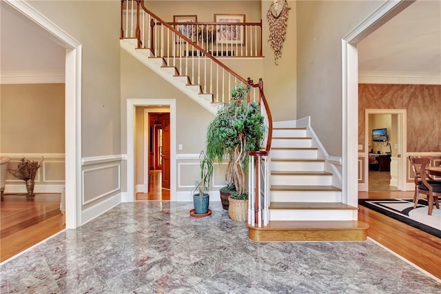 foyer entrance featuring crown molding