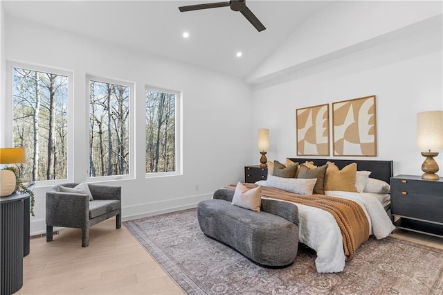 bedroom with lofted ceiling, ceiling fan, and light hardwood / wood-style flooring