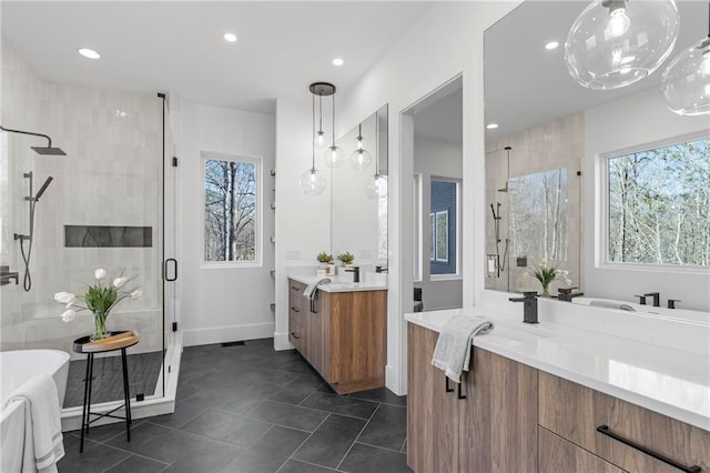 bathroom featuring tile patterned floors, vanity, and shower with separate bathtub