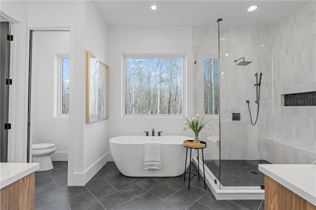 full bathroom with vanity, toilet, independent shower and bath, and tile patterned flooring