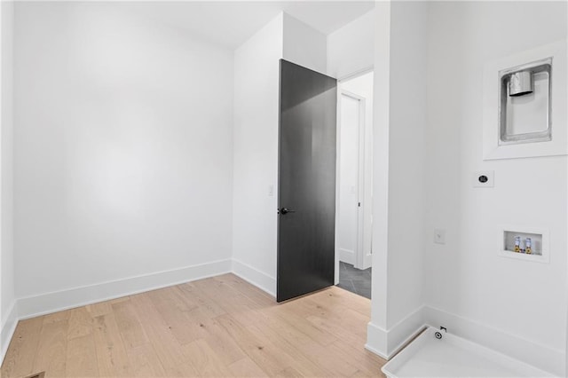 interior space featuring electric dryer hookup, washer hookup, and light hardwood / wood-style flooring