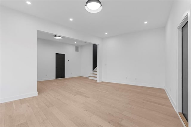 empty room with light hardwood / wood-style flooring