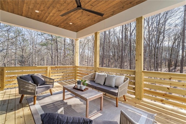 deck with an outdoor living space and ceiling fan