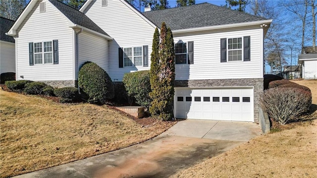 view of front of property with a front yard and a garage