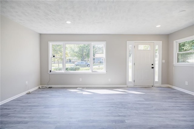 entrance foyer with hardwood / wood-style flooring and a textured ceiling