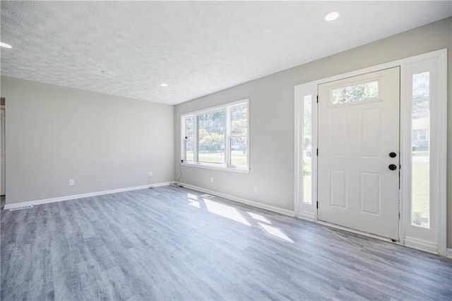 entrance foyer featuring hardwood / wood-style floors and a textured ceiling