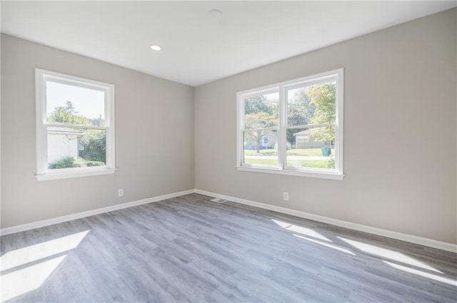 spare room featuring light hardwood / wood-style flooring