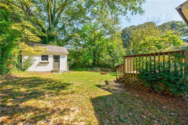 view of yard with a deck and a storage shed