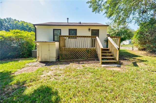 back of house with a wooden deck, a yard, and central AC unit