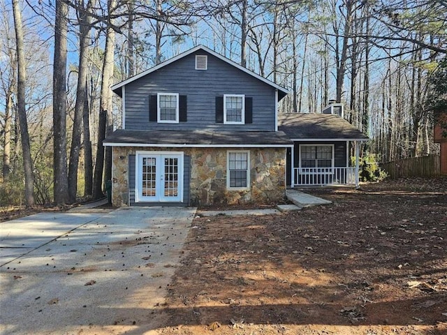 rear view of house with a porch and french doors