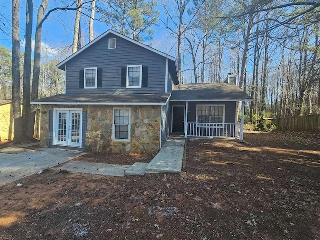 rear view of house featuring french doors and covered porch