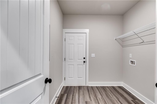 laundry room with washer hookup and hardwood / wood-style flooring