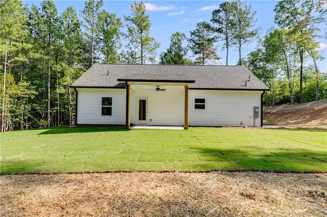 back of house featuring a lawn, ceiling fan, and a patio