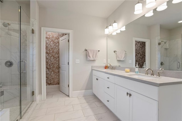 bathroom featuring marble look tile flooring, a stall shower, baseboards, and double vanity