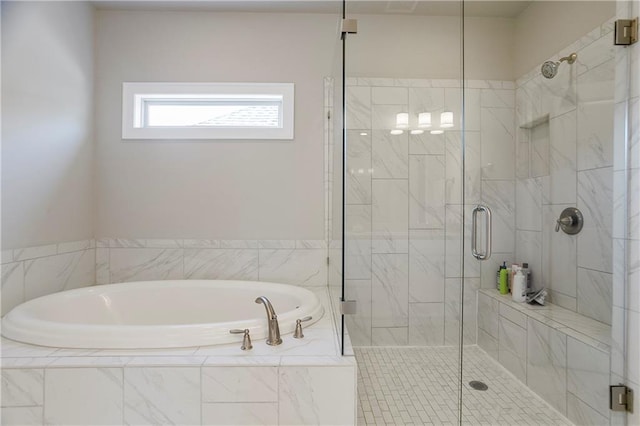 bathroom featuring a bath and a shower stall