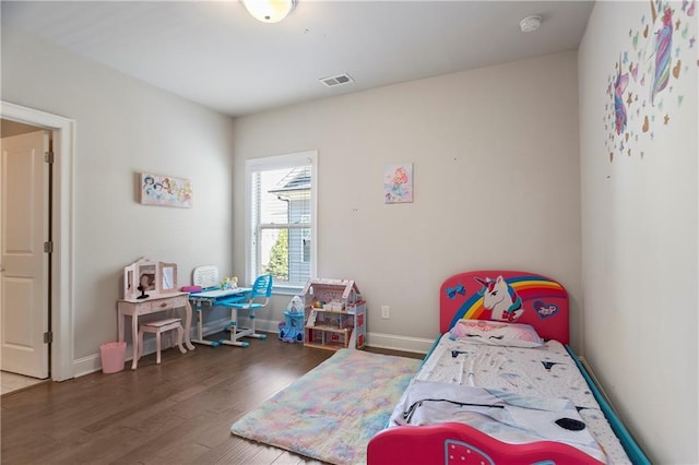 bedroom with wood finished floors and baseboards