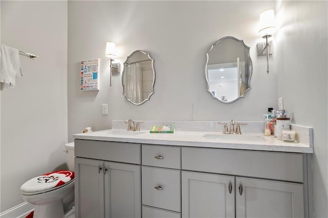full bath featuring toilet and double vanity