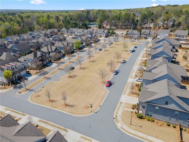aerial perspective of suburban area featuring a heavily wooded area