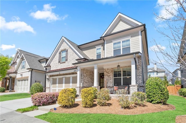 craftsman-style home featuring a porch, a garage, brick siding, fence, and concrete driveway