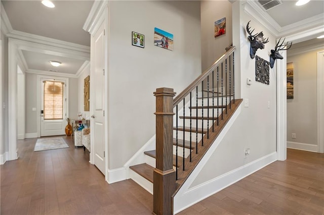 staircase featuring hardwood / wood-style floors, baseboards, crown molding, and recessed lighting