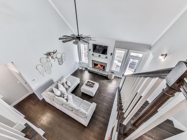 711 Carver Mill Rd, Talking Rock, GA 30175 - living room with a lit fireplace, a ceiling fan, wood finished floors, stairway, and a towering ceiling