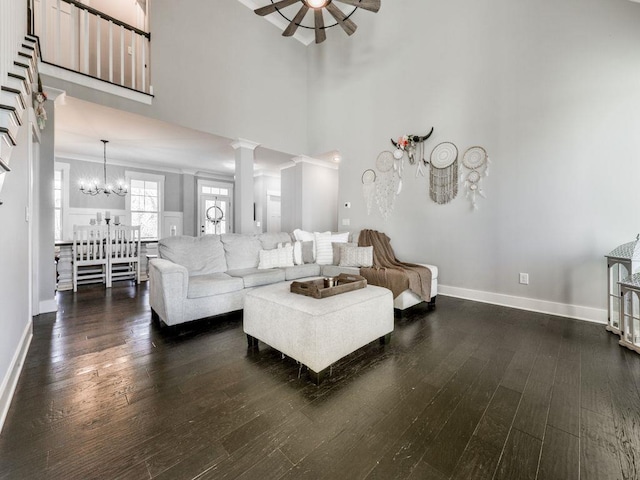 711 Carver Mill Rd, Talking Rock, GA 30175 - living room with dark wood-style floors, a chandelier, a towering ceiling, a ceiling fan, and ornate columns