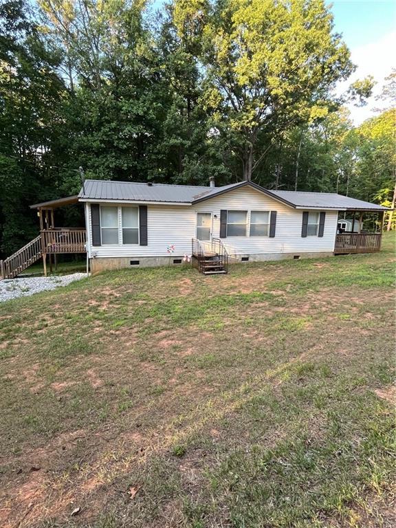 rear view of property with a lawn