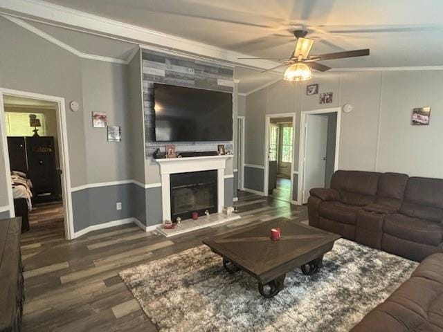 living room with a tile fireplace, hardwood / wood-style floors, lofted ceiling, ceiling fan, and crown molding