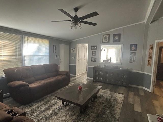 living room featuring dark hardwood / wood-style flooring, ornamental molding, lofted ceiling, and ceiling fan