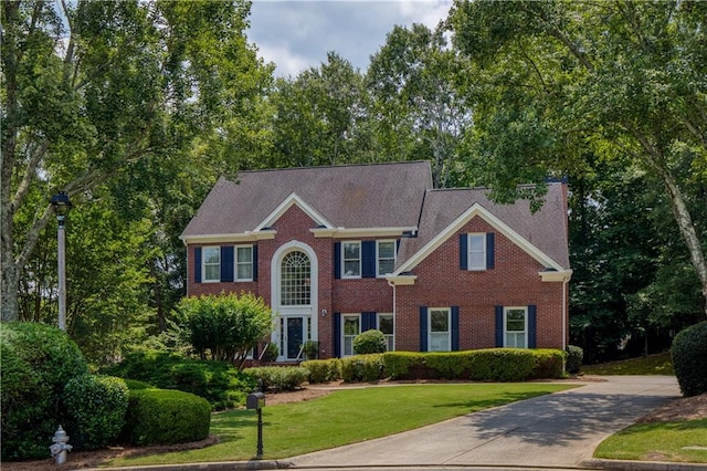 755 Creek Wind Ct, Johns Creek, GA 30097 - colonial house featuring a front yard, brick siding, and driveway