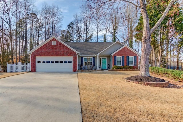 ranch-style home featuring driveway, brick siding, an attached garage, and fence