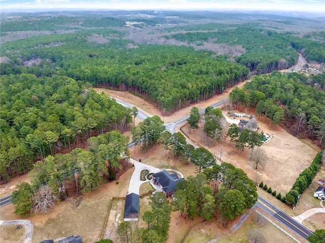 birds eye view of property with a view of trees