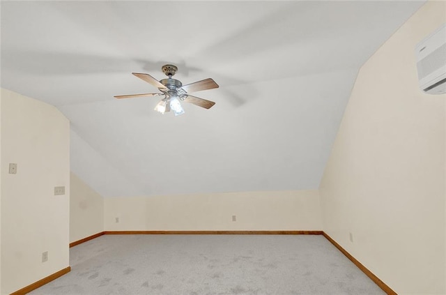 additional living space with light carpet, baseboards, a ceiling fan, a wall mounted air conditioner, and vaulted ceiling