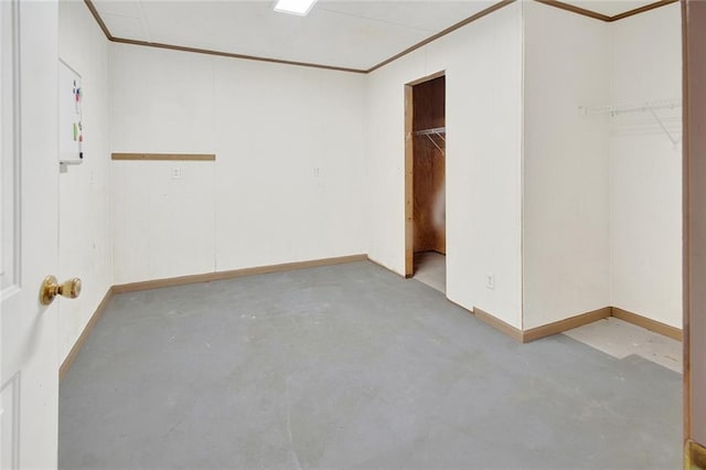 unfurnished bedroom with baseboards, concrete floors, and ornamental molding