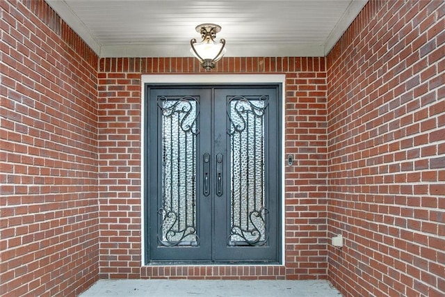 doorway to property with french doors and brick siding