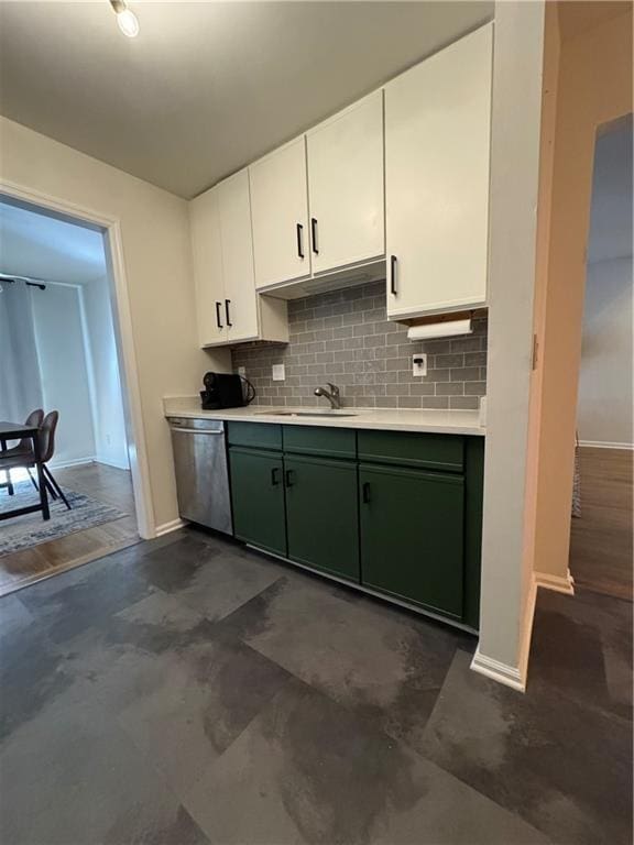 kitchen with tasteful backsplash, light countertops, stainless steel dishwasher, white cabinets, and green cabinetry