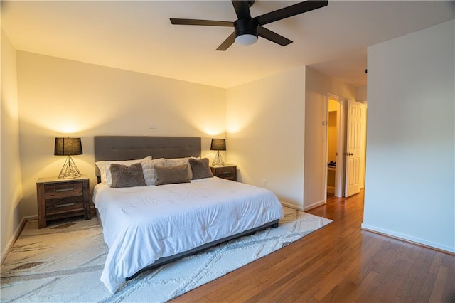 bedroom with ceiling fan, baseboards, and hardwood / wood-style floors