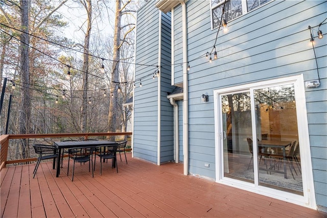 wooden terrace with outdoor dining area