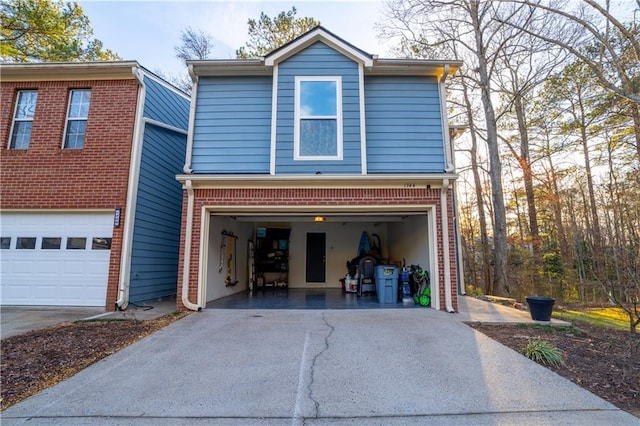 view of front of home featuring a garage, aphalt driveway, and brick siding