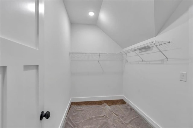 walk in closet featuring vaulted ceiling