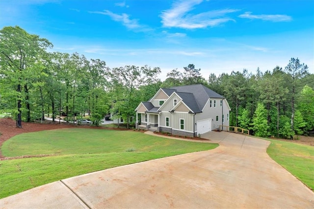 craftsman inspired home with board and batten siding, concrete driveway, an attached garage, and a front yard