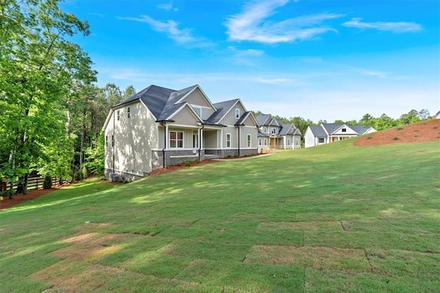 view of front facade featuring a front yard, board and batten siding, and a residential view