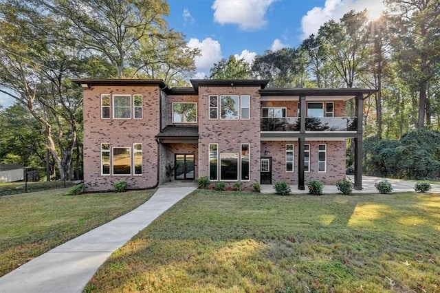 view of front of property with a balcony and a front yard