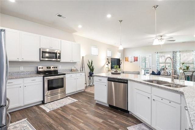 11 Rambling Oaks Dr NE, Rome, GA 30165 - kitchen featuring stainless steel appliances, white cabinets, dark wood finished floors, recessed lighting, and light stone countertops
