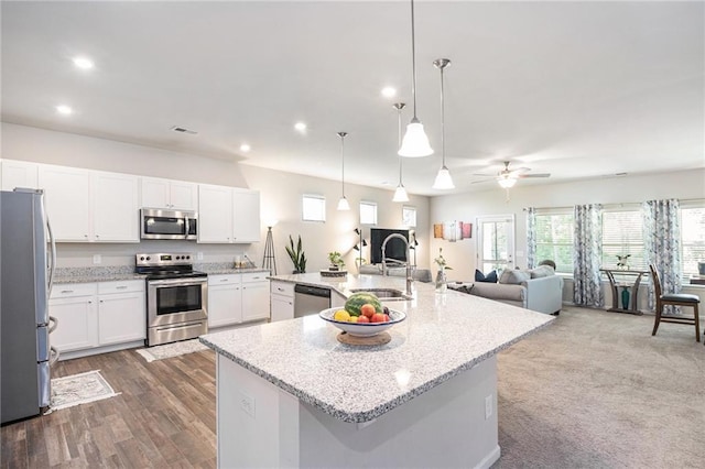 11 Rambling Oaks Dr NE, Rome, GA 30165 - kitchen featuring stainless steel appliances, white cabinetry, open floor plan, recessed lighting, and a spacious island