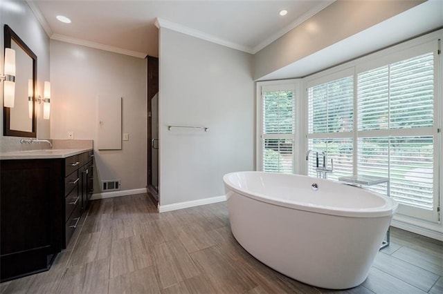 3030 Spalding Dr, Sandy Springs, GA 30350 - bathroom with vanity, a freestanding tub, crown molding, a stall shower, and recessed lighting