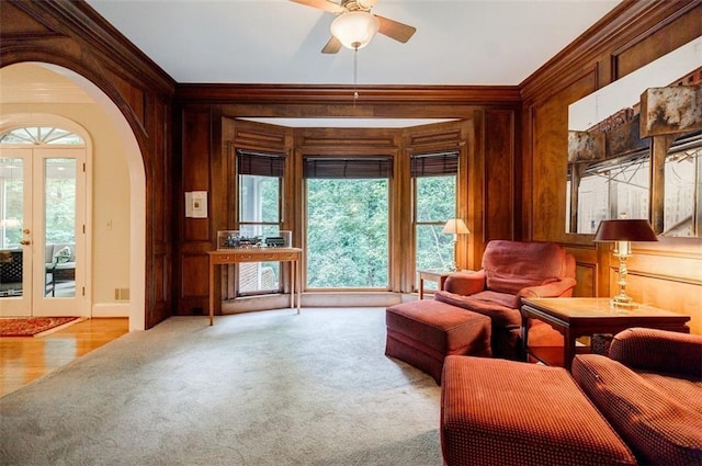 3030 Spalding Dr, Sandy Springs, GA 30350 - sitting room featuring ornamental molding, carpet, wood walls, a ceiling fan, and healthy amount of natural light