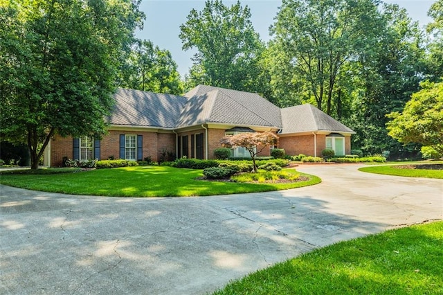 3030 Spalding Dr, Sandy Springs, GA 30350 - ranch-style home featuring brick siding, curved driveway, and a front lawn
