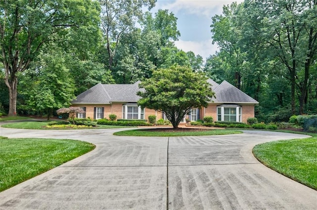 3030 Spalding Dr, Sandy Springs, GA 30350 - view of front of home with curved driveway, a front lawn, and brick siding